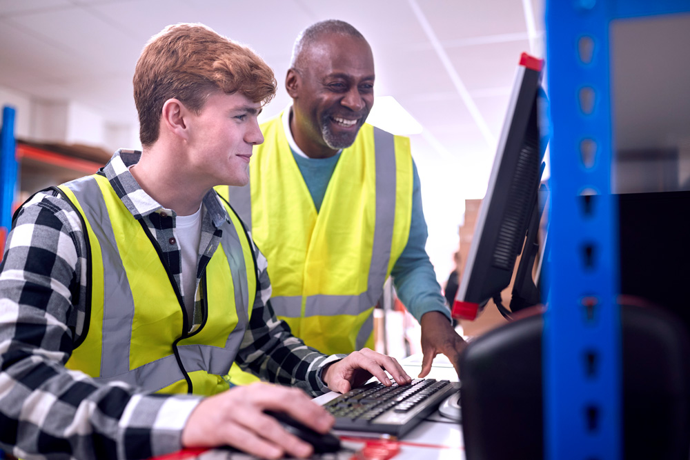 man and woman looking at work materials in a landscaping setting